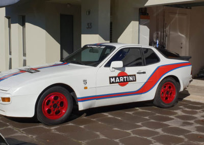 A Porsche fitted with mag wheels that have been powder coated red